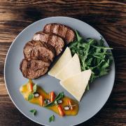  Beef escalope tagliata with tomatoes, salad mix and parmesan cheese